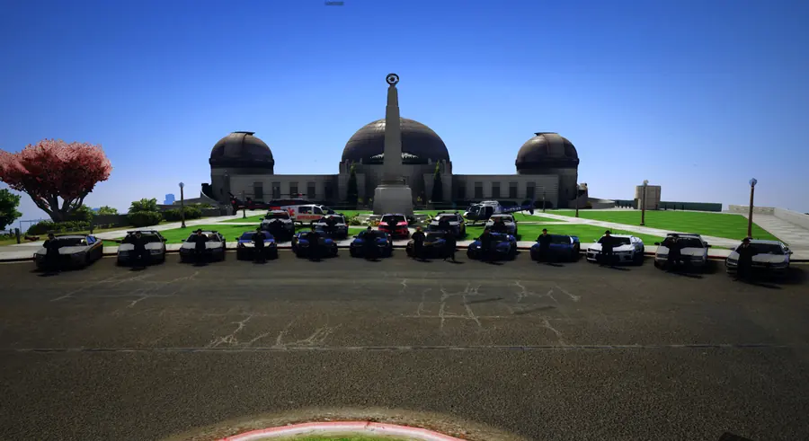 Police units lined up in front of the observatory on a clear day